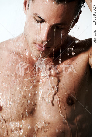 Man in shower cleaning hair, skin and body for morning wellness, hygiene and routine. Grooming, skincare and face of male model with muscle washing with water, healthy self care and calm in bathroom 139593927