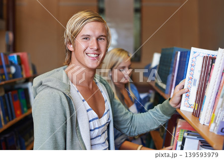 Portrait, book or happy man in library to search at university, college or school campus for education. Bookshelf, learning or student with scholarship studying knowledge, research and information Portrait, book or happy man in library to search at university, college or school campus for education. Bookshelf, learning or student with scholarship studying knowledge, research and information 139593979