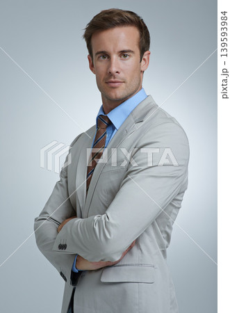 Portrait, serious and business man with arms crossed for pride in corporate career. Face, confident professional lawyer and attorney working in a suit isolated on gray studio background in Australia Portrait, serious and business man with arms crossed for pride in corporate career. Face, confident professional lawyer and attorney working in a suit isolated on gray studio background in Australia 139593984