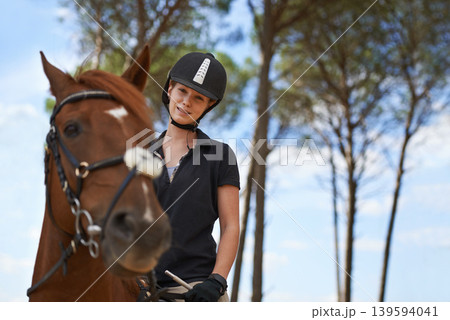 Equestrian, portrait and riding a horse in nature on adventure, journey and happiness in countryside. Ranch, animal and rider outdoor with hobby, sport and pet on farm with girl on blue sky in summer Equestrian, portrait and riding a horse in nature on adventure, journey and happiness in countryside. Ranch, animal and rider outdoor with hobby, sport and pet on farm with girl on blue sky in summer 139594041