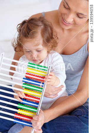Abacus, education and baby with mother playing, learning and teaching for child development on bed. Bonding, toy and closeup of mom helping kid, infant or toddler with counting in bedroom at home. Abacus, education and baby with mother playing, learning and teaching for child development on bed. Bonding, toy and closeup of mom helping kid, infant or toddler with counting in bedroom at home. 139594058