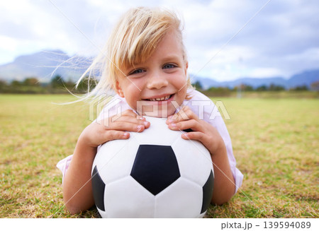 Child, soccer player and ball with portrait, smile and ready for game, field and girl. Outdoor, playful and sport for childhood, happy and athlete for match, alone and outside on football pitch Child, soccer player and ball with portrait, smile and ready for game, field and girl. Outdoor, playful and sport for childhood, happy and athlete for match, alone and outside on football pitch 139594089