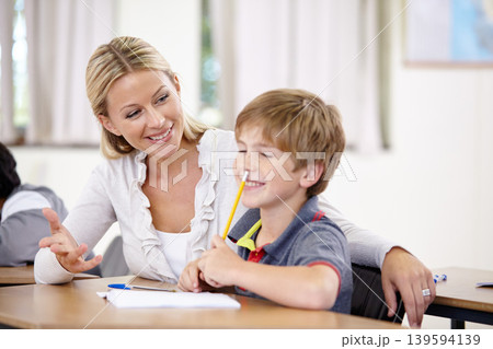 Teacher, student and helping with school work in classroom, question and think of answer for education and knowledge. Teaching, learn and woman with boy in class, study and problem solving for test Teacher, student and helping with school work in classroom, question and think of answer for education and knowledge. Teaching, learn and woman with boy in class, study and problem solving for test 139594139