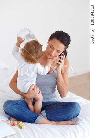 Phone call, playing and mother with baby on bed for communication and bonding together at modern house. Discussion, fun and young mom on mobile conversation and holding toddler in bedroom at home. 139594213