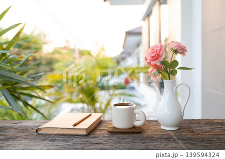 Cozy writing and coffee with vase of pink Cozy writing and coffee with vase of pink 139594324