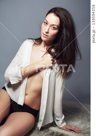 Portrait, underwear and woman in shirt for beauty in studio isolated on a gray background. Body, confidence and fashion of young female model in natural clothes or lingerie on a backdrop in Brazil Portrait, underwear and woman in shirt for beauty in studio isolated on a gray background. Body, confidence and fashion of young female model in natural clothes or lingerie on a backdrop in Brazil 139594359
