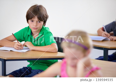 Children, education and boy writing a test, knowledge and learning with an exam, information and school. Kids, classroom and child development with a notebook, studying and desk with girl or creative Children, education and boy writing a test, knowledge and learning with an exam, information and school. Kids, classroom and child development with a notebook, studying and desk with girl or creative 139594535