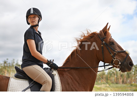 Equestrian, riding and woman on horse in nature on adventure and journey in countryside. Ranch, animal and rider outdoor with hobby, sport or pet on farm trail with girl in summer on blue sky Equestrian, riding and woman on horse in nature on adventure and journey in countryside. Ranch, animal and rider outdoor with hobby, sport or pet on farm trail with girl in summer on blue sky 139594808