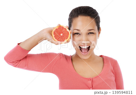 Portrait, woman and excited with grapefruit for healthy detox, vegan diet and eco nutrition in studio on white background. Model, fruits and smile for sustainable benefits of vitamin c in citrus food 139594811