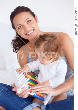 Smile, portrait and baby with mother on abacus playing, learning and teaching for child development on bed. Bonding, toy and mom with kid, infant or toddler with counting in bedroom at home. 139594822