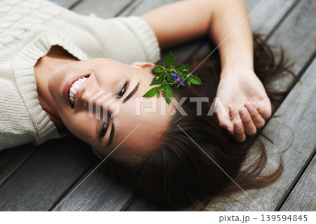 Woman lying on her porch, relax and summer with smile, happiness and chilling on a weekend break. Person, outdoor and girl with joy, cheerful and plant in her hair, holiday and floral with vacation Woman lying on her porch, relax and summer with smile, happiness and chilling on a weekend break. Person, outdoor and girl with joy, cheerful and plant in her hair, holiday and floral with vacation 139594845