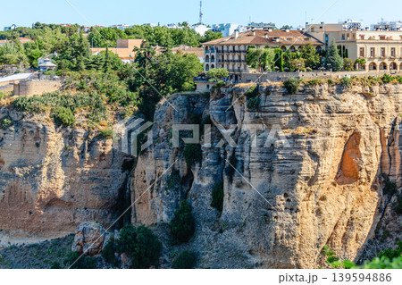 The picturesque town of Ronda in Spain is located on a cliff. 139594886