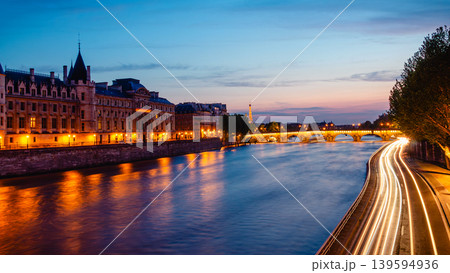 View of Paris by night with the Seine river and the Conciergerie building 139594936