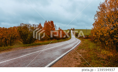 Scenic autumn road winding through colorful trees Scenic autumn road winding through colorful trees 139594937