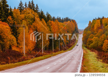 Scenic autumn road winding through colorful trees Scenic autumn road winding through colorful trees 139594938