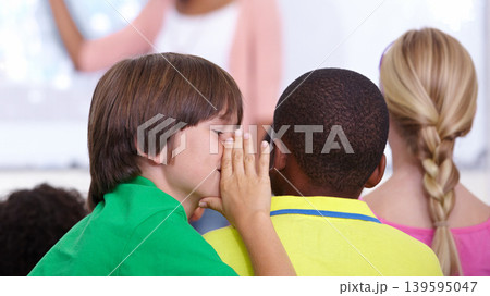 Children, whisper and classroom in ear for secret, gossip or communication in lesson at school. Person, students or friends listening to rumor, information or eavesdrop in class together with teacher 139595047