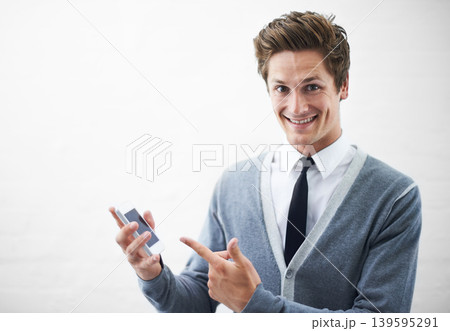 Business man, show phone and studio portrait with mockup space, pointing or happy by white background. Person, entrepreneur and tech startup employee in presentation, choice and smartphone with pride 139595291