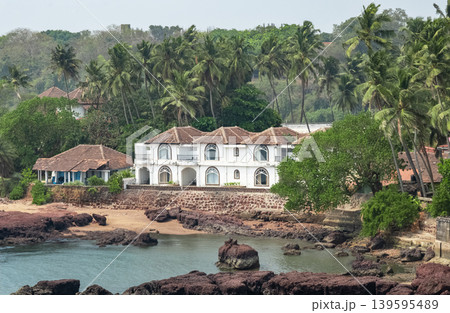 Guesthouses and palm trees on the coast of Goa India. Guesthouses and palm trees on the coast of Goa India. 139595489