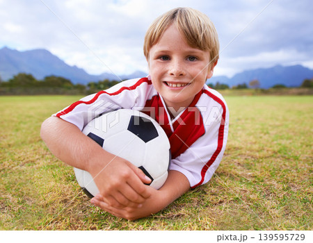 Happy, soccer player and ball with portrait, exercise and ready for game, field and child. Outdoor, playful and sport for childhood, smile and athlete for match, alone and outside on football pitch Happy, soccer player and ball with portrait, exercise and ready for game, field and child. Outdoor, playful and sport for childhood, smile and athlete for match, alone and outside on football pitch 139595729