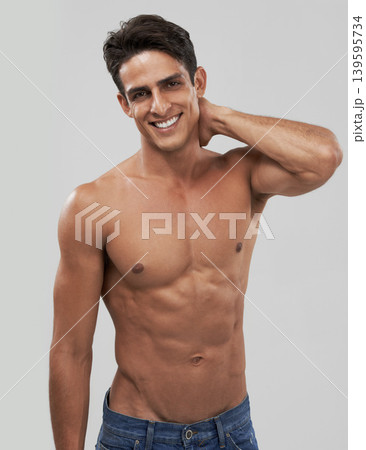 Man, portrait and happy or shirtless bodybuilder in studio, smile and fitness by gray background. Male person, abs and strong core or muscular abdomen, confident and results or progress from exercise Man, portrait and happy or shirtless bodybuilder in studio, smile and fitness by gray background. Male person, abs and strong core or muscular abdomen, confident and results or progress from exercise 139595734