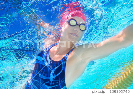 Underwater, woman and swimming with fitness, stroke and sports with exercise, healthy and active. Person, wet and athlete with race, competition and indoor pool with wellness, breathing and splash Underwater, woman and swimming with fitness, stroke and sports with exercise, healthy and active. Person, wet and athlete with race, competition and indoor pool with wellness, breathing and splash 139595740