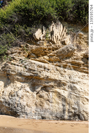 Rock formation with layered textures and vegetation on coastal cliff Selective focus Rock formation with layered textures and vegetation on coastal cliff Selective focus 139595764