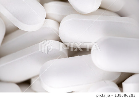 Macro close up of white oval medical pills background Macro close up of white oval medical pills background 139596283