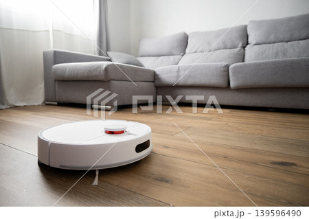 Robot vacuum cleaner cleaning wooden floor Robot vacuum cleaner cleaning wooden floor 139596490