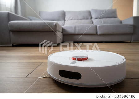 Robot vacuum cleaner cleaning wooden floor Robot vacuum cleaner cleaning wooden floor 139596496