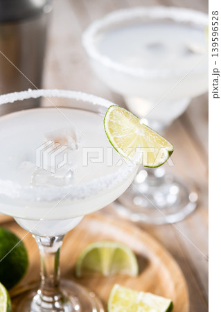 Classic margarita cocktail with lime and salt rim 139596528