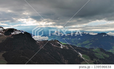 Aerial view of alpine valley with mountains and clouds Aerial view of alpine valley with mountains and clouds 139596638