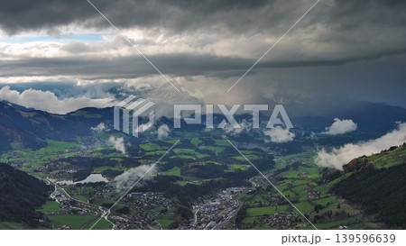 Aerial view of alpine valley with mountains and clouds Aerial view of alpine valley with mountains and clouds 139596639
