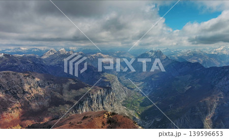 Aerial view of rocky mountain peak and green valley Aerial view of rocky mountain peak and green valley 139596653