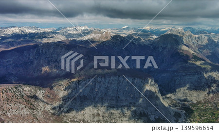 Aerial view of rocky mountain peak and green valley 139596654