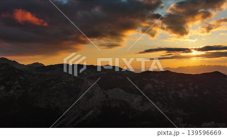 Sunset over mountain with dramatic clouds 139596669