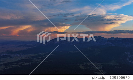 Sun setting over mountain and evening sky 139596679