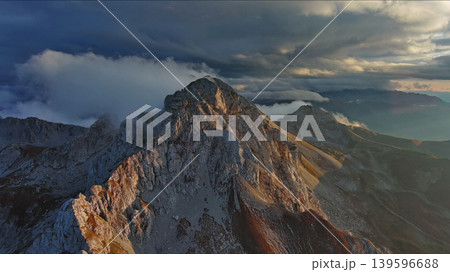 Amazing rocky mountains in clouds at sunset Amazing rocky mountains in clouds at sunset 139596688