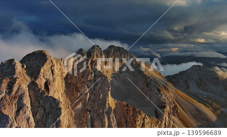 Amazing rocky mountains in clouds at sunset Amazing rocky mountains in clouds at sunset 139596689