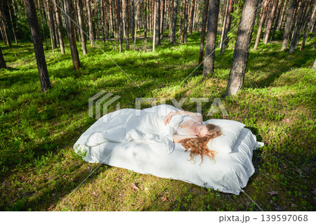 Woman sleeps on a mattress in the summer forest 139597068