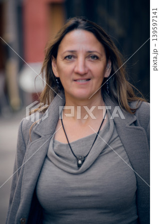 portrait of a young woman on a city street portrait of a young woman on a city street 139597141