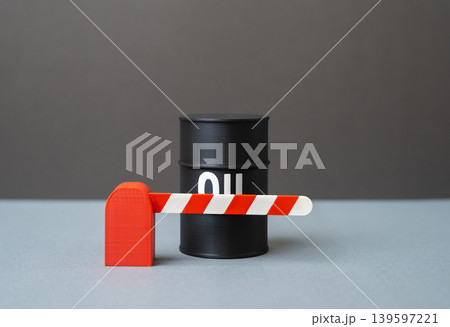 A barrel of oil behind a barrier. Blockade and restrictions on the supply and transportation of oil. Embargo, sanctions pressure and disruption of global trade routes. A barrel of oil behind a barrier. Blockade and restrictions on the supply and transportation of oil. Embargo, sanctions pressure and disruption of global trade routes. 139597221