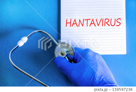 Hantavirus medical words symbol. Concept words Hantavirus on beautiful white note. Beautiful blue background. Doctor hand with pen. Blue glove. Stethoscope. Medical Hantavirus concept. Copy space. 139597236