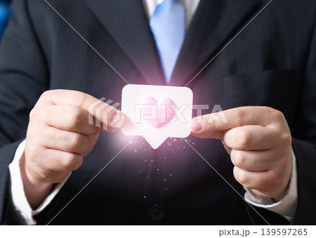A businessman holding a like sign. Feedback and anonymous employee surveys. Feedback and public outreach. Customer engagement, approval ratings and corporate communication strategy. 139597265