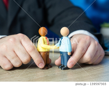 A businessman helps close a deal. Mediate between parties and conclude a contract. Resolve disputes and end conflicts. Negotiation and partnership building. A businessman helps close a deal. Mediate between parties and conclude a contract. Resolve disputes and end conflicts. Negotiation and partnership building. 139597303