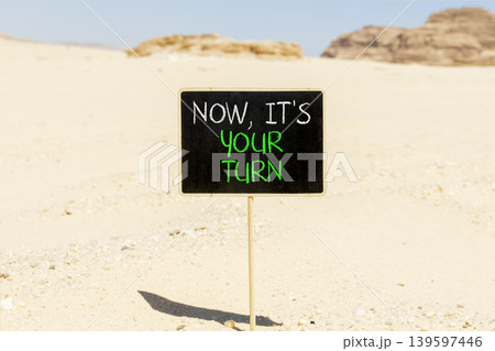 Now it's your turn symbol. Concept words Now it's your turn on beautiful blackboard. Beautiful Sinai desert sand background. Business Now it's your turn motivational support concept. Copy space. Now it's your turn symbol. Concept words Now it's your turn on beautiful blackboard. Beautiful Sinai desert sand background. Business Now it's your turn motivational support concept. Copy space. 139597446