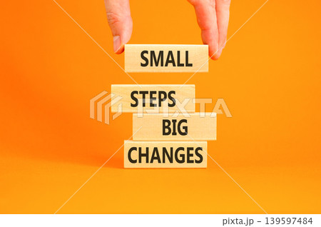 Small steps big changes words symbol. Concept words Small steps big changes on beautiful wooden blocks. Beautiful orange background. Business motivational small steps big changes concept. Copy space. Small steps big changes words symbol. Concept words Small steps big changes on beautiful wooden blocks. Beautiful orange background. Business motivational small steps big changes concept. Copy space. 139597484