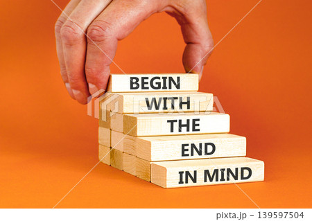 Begin with the end in mind symbol. Concept words Begin with the end in mind on beautiful wooden blocks. Beautiful orange paper background. Business begin with the end in mind concept. Copy space. 139597504