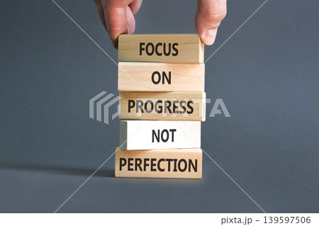 Progress or perfection words symbol. Concept words Focus on progress not perfection on beautiful wooden blocks. Beautiful grey paper background. Business progress or perfection concept. Copy space. 139597506