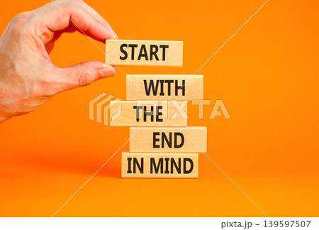Start with the end in mind symbol. Concept words Start with the end in mind on beautiful wooden blocks. Beautiful orange paper background. Business start with the end in mind concept. Copy space. 139597507