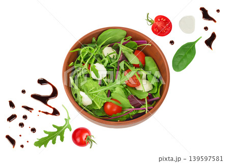 Mix salad - arugula, spinach, chard, cherry tomatoes and mozzarella in the bowl isolated on white background. Top view. Flat lay Mix salad - arugula, spinach, chard, cherry tomatoes and mozzarella in the bowl isolated on white background. Top view. Flat lay 139597581